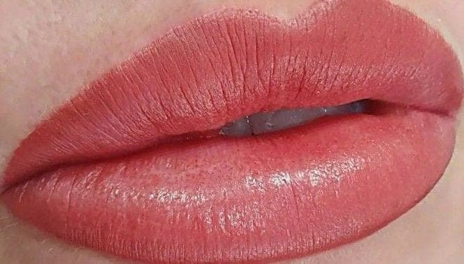 Full lip colour in coral, close up