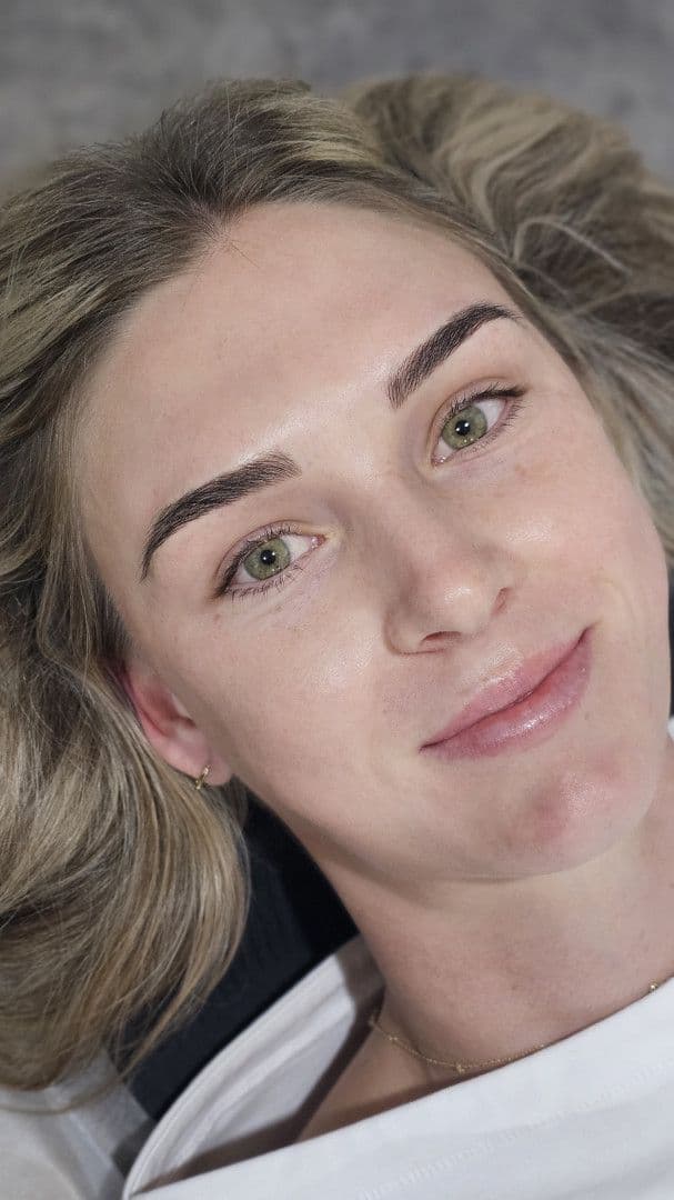 A client in the studio chair with finished, natural-looking brows