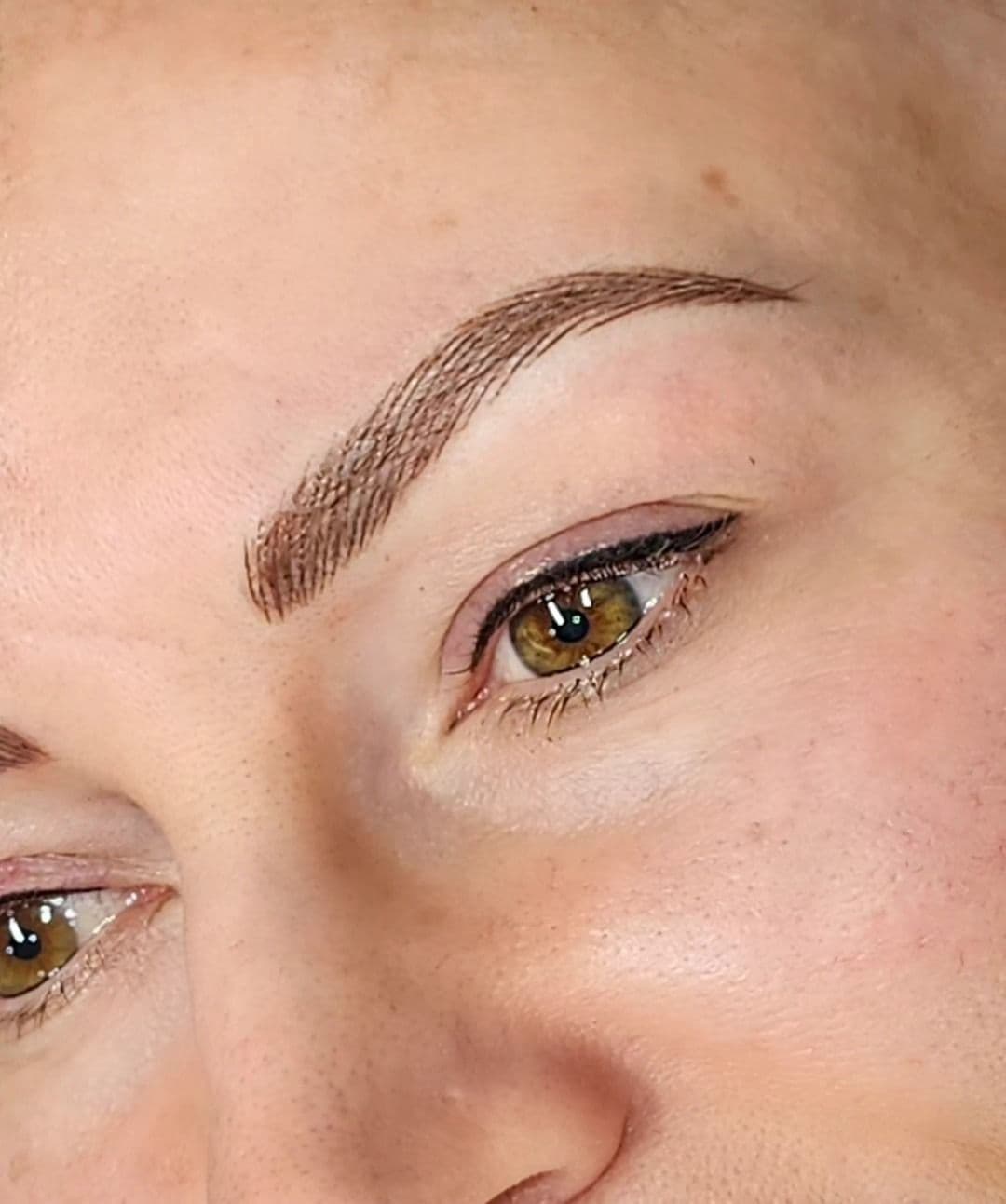 Hair-stroke eyebrow tattoo, close up