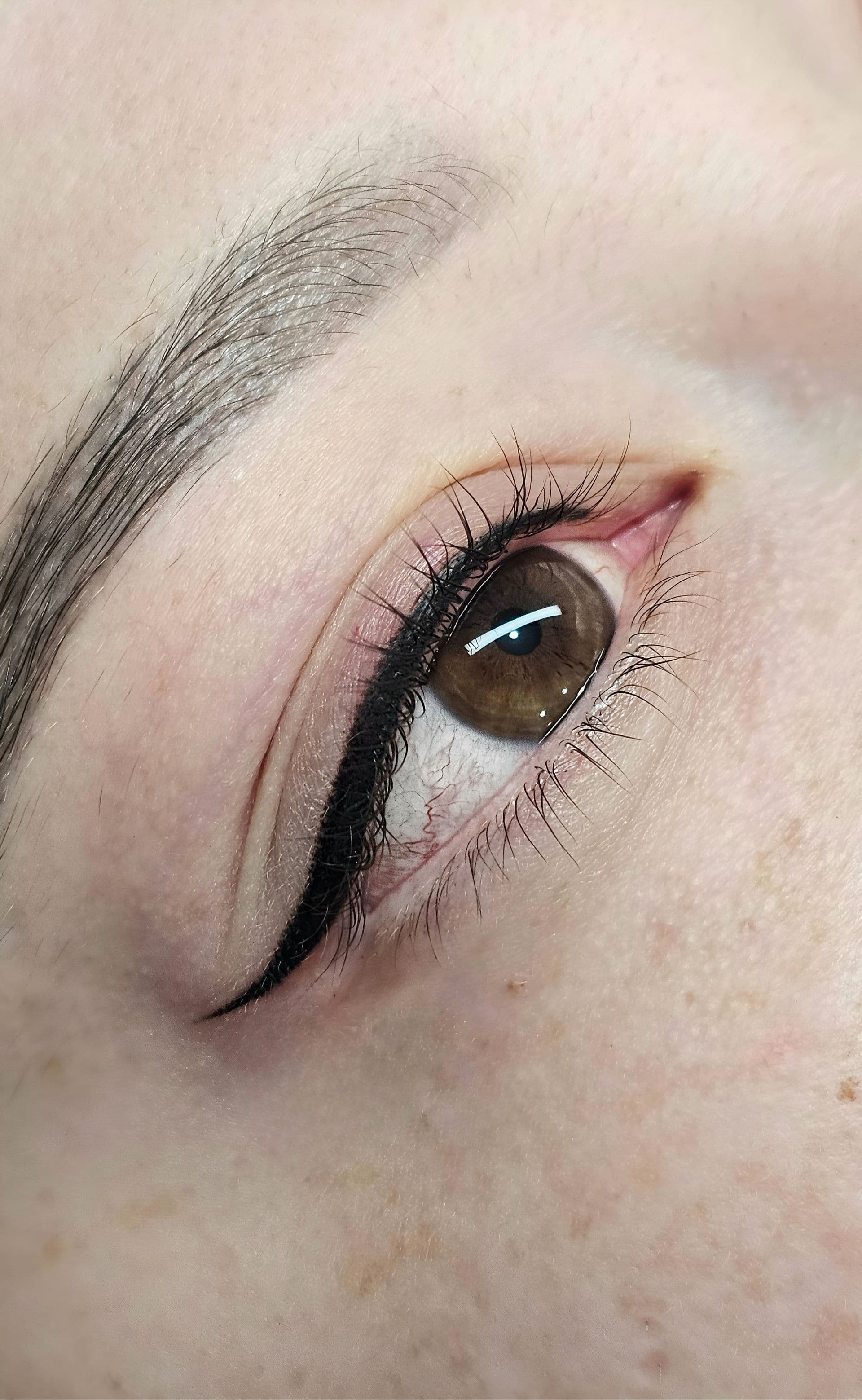 Fine designer eyeliner with a short wing, seen from above